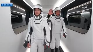 SpaceX's Crew-3 astronaut Matthias Maurer of the European Space Agency waves as he and NASA astronaut Kayla Barron walk across the gantry to board their Crew Dragon Endurance.Operations and Checkout Building at the Kennedy Space Center in Florida to head to the launch pad for their Nov. 10, 2021 launch to the International Space Station.